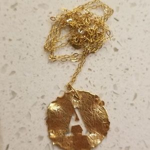 A initial necklace in gold